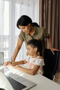 Parent helping child through remote instruction