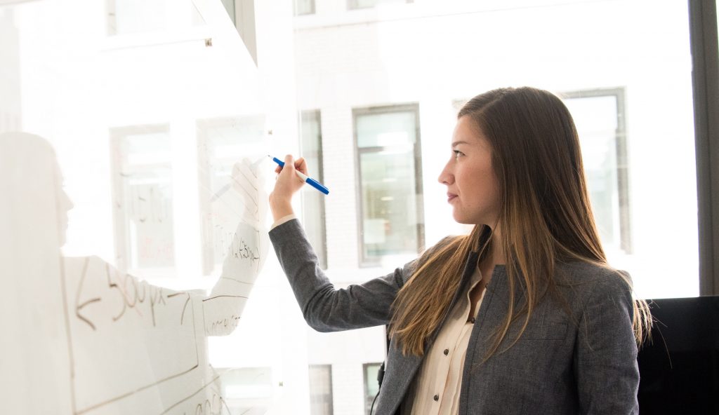 teacher writing on board, how education leaders motivate teachers